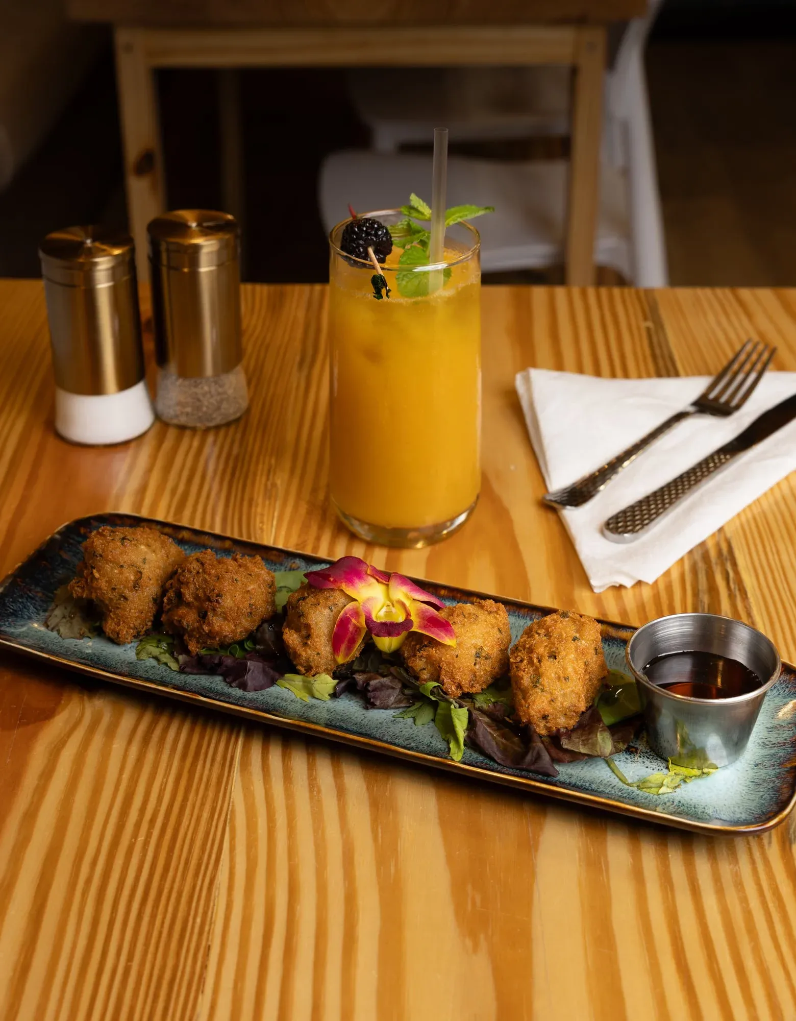 Crispy malanga fritters drizzled with honey at Sensaciones